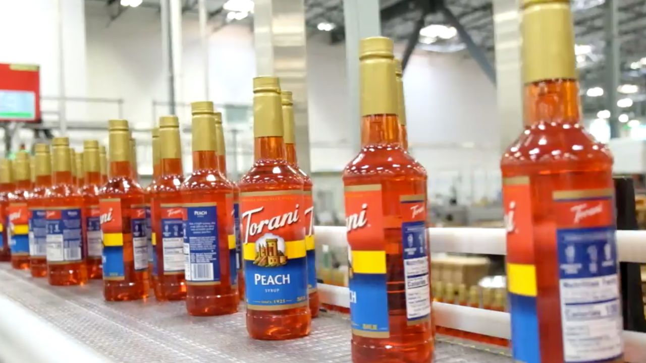 Bottles of Torani Peach syrup move down the production line at the company's new manufacturing facility in San Leandro, California.