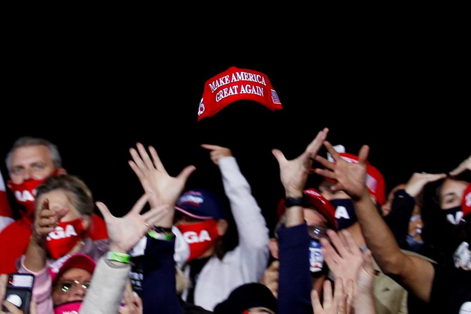 Trump supporters try to catch a hat during a campaign event in Fayetteville, North Carolina, on September 19.