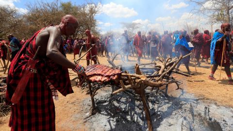 Maasai youth roast meat for the celebrants before attending the rites of passage initiation ceremony. The event was initially postponed due to the coronavirus disease outbreak in Maparasha hills of Kajiado, Kenya. 