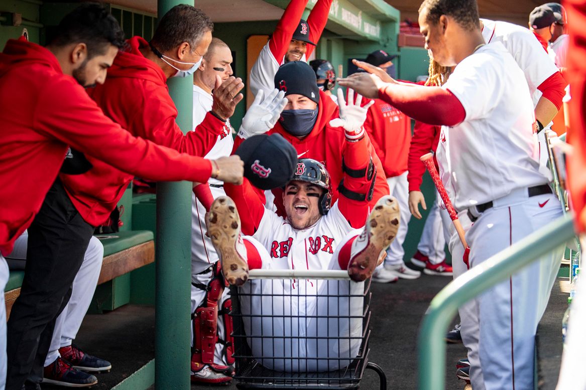 Boston Red Sox infielder Michael Chavis celebrates with the team after hitting a three-run home run during the third inning against the New York Yankees on Sunday, September 20, at Fenway Park in Boston.