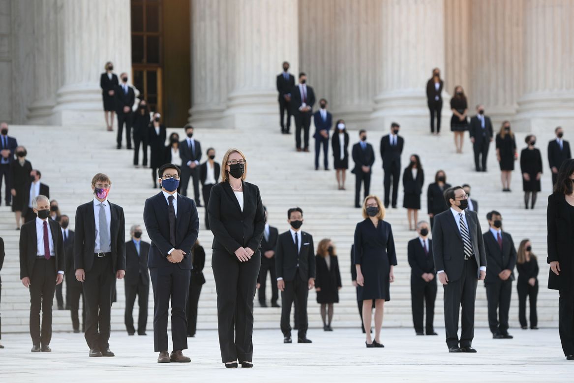 Former clerks of Justice Ruth Bader Ginsburg wait for her casket to arrive at the US Supreme Court in Washington on Wednesday, September 23.