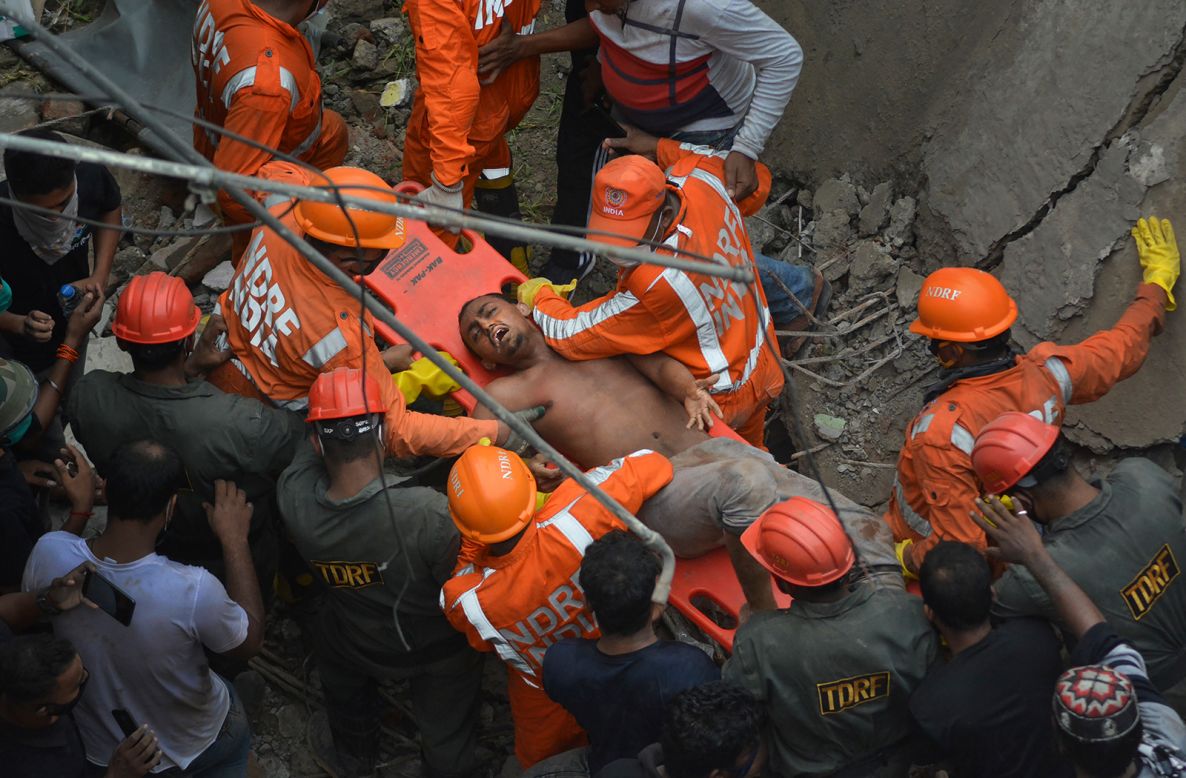 A man is rescued from a collapsed building in Bhiwandi, near Mumbai, India, on Monday, September 21. 