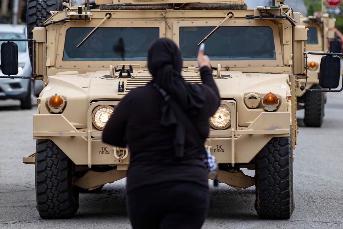 A woman confronts a National Guard vehicle in Louisville, Kentucky, during protests following the Breonna Taylor decision on Wednesday, September 23. 