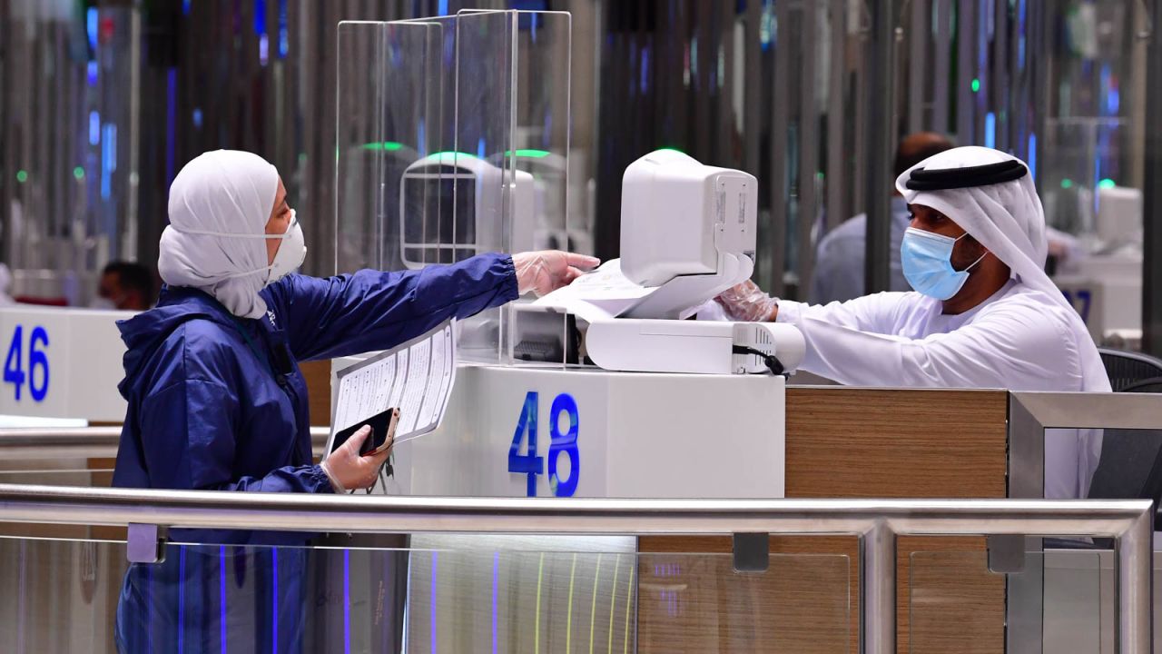 A tourist gets her papers checked upon arrival at Teminal 3 at Dubai airport.