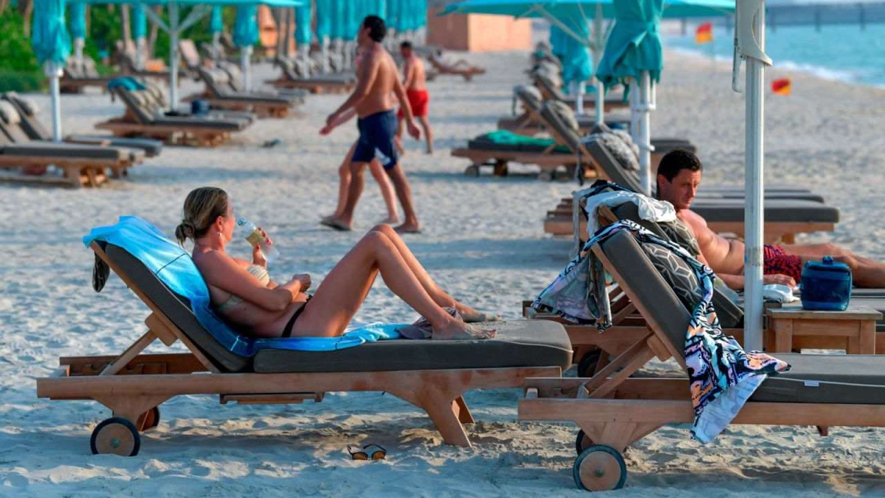 Tourists sunbathe at the beach of the Al Naseem hotel in Dubai.