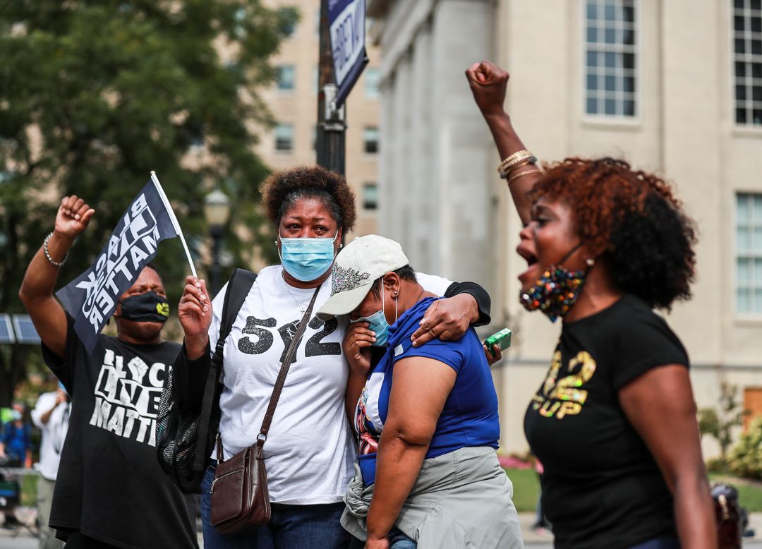 Christina Johnson chants Breonna Taylor's name as three women huddle following the grand jury announcement in Louisville, Kentucky, on Wednesday, September 23.