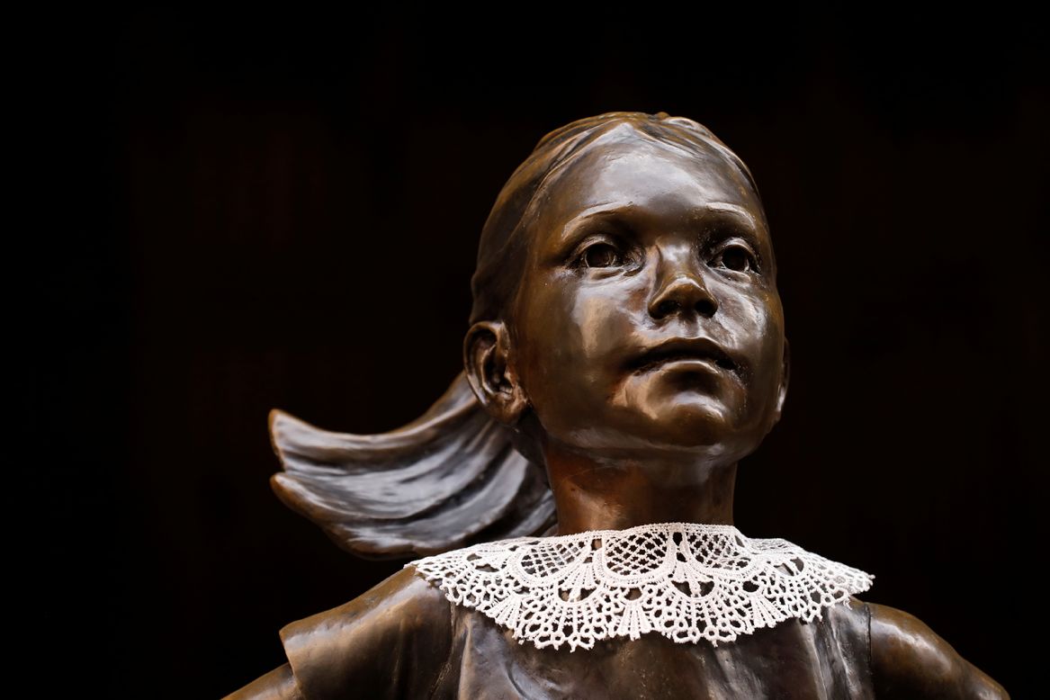The Fearless Girl statue wears a jabot collar in honor of Justice Ruth Bader Ginsburg outside the New York Stock Exchange Building in Manhattan on Monday, September 21.