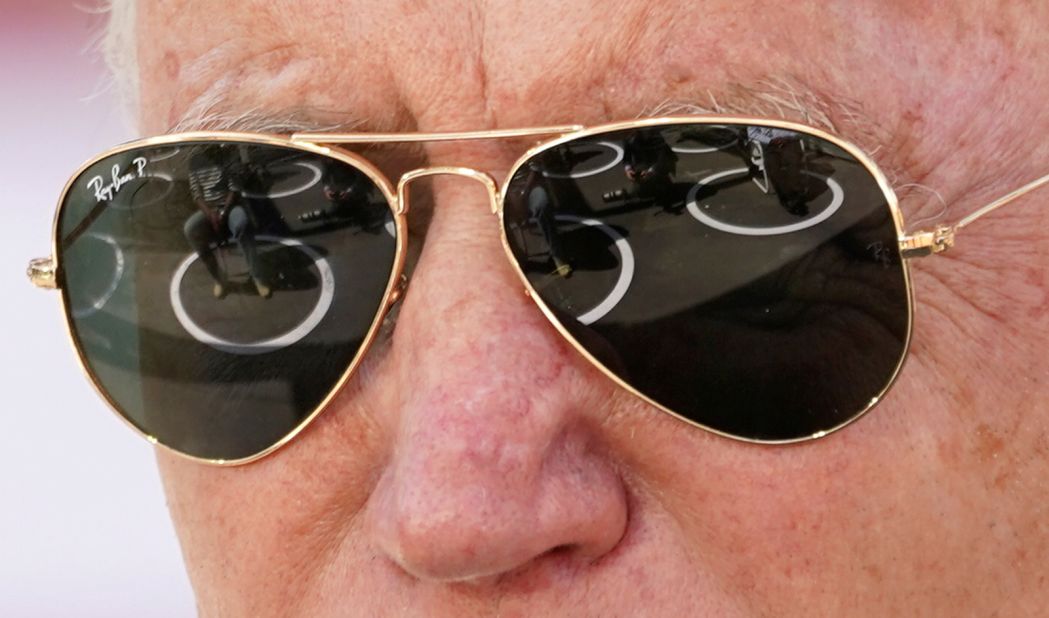 People sitting in social-distancing circles are reflected in Biden's sunglasses as he speaks in Charlotte, North Carolina.