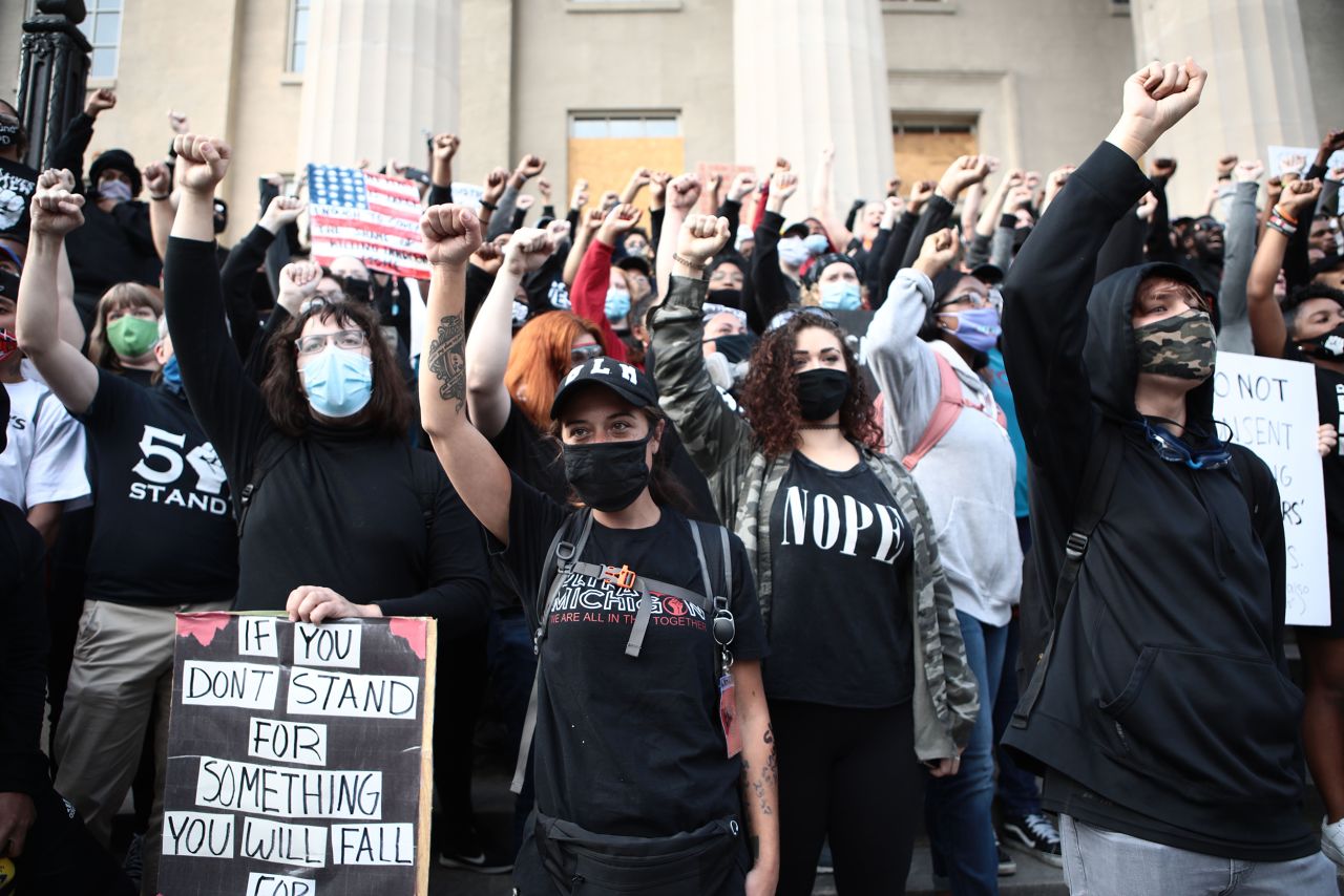 Supporters of Breonna Taylor raise their fists near Jefferson Square Park in Louisville on September 24.