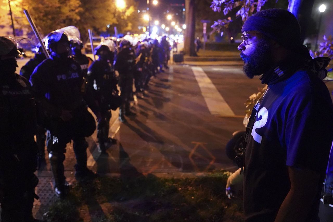 Police speak with protesters at the First Unitarian Church on Thursday in Louisville.