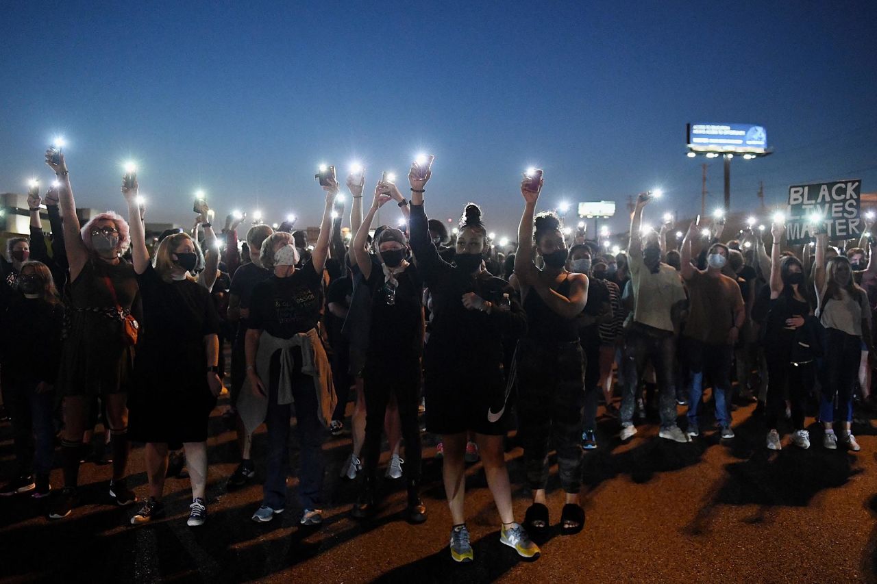 Protesters light up their cell phones during a demonstration on Interstate 64 in St. Louis, Missouri, on Thursday, September 24.
