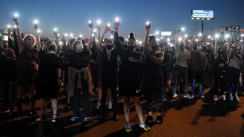 Protesters light up their phones during a protest Thursday in St Louis, Missouri, in response to a Kentucky grand jury not bringing charges against police officers in the death of Breonna Taylor. 