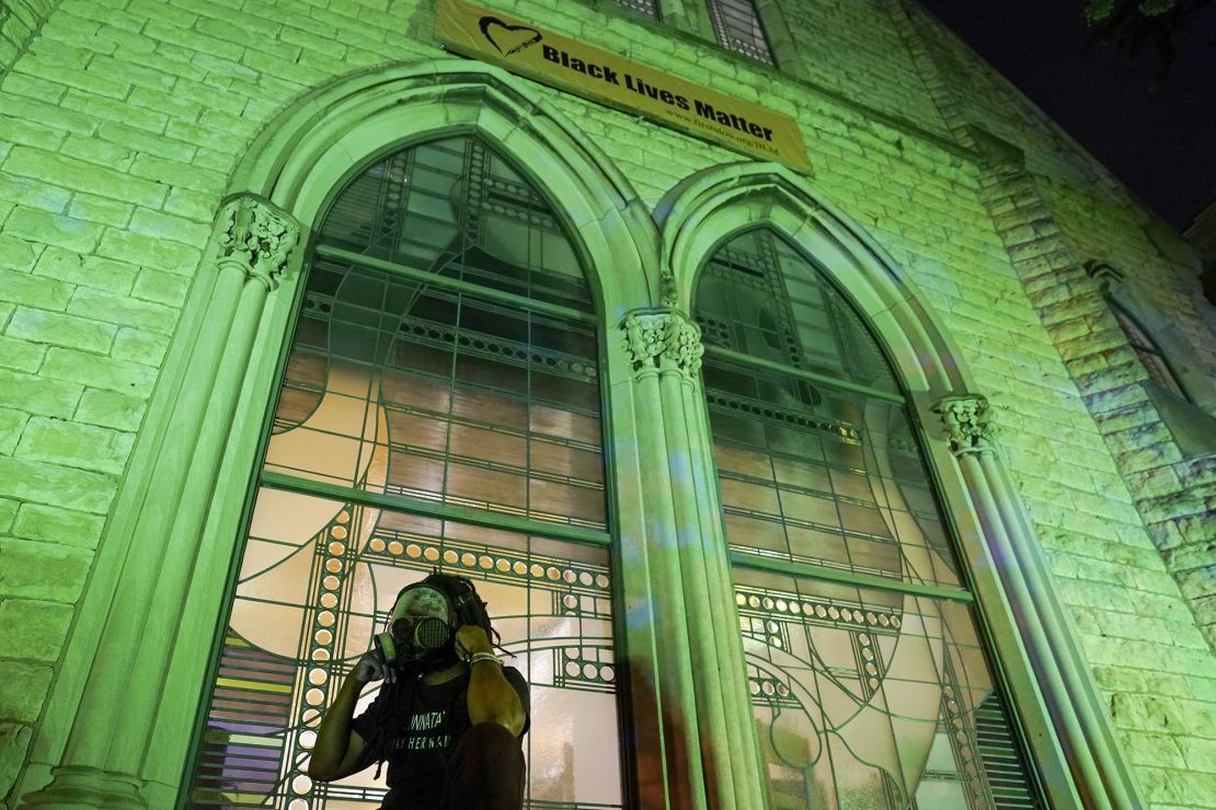 A protester wears a gas mask outside The First Unitarian church, Thursday, Sept. 24, 2020, in Louisville, Kentucky. 