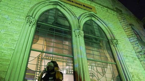 A protester wears a gas mask outside The First Unitarian church, Thursday, Sept. 24, 2020, in Louisville, Kentucky. 