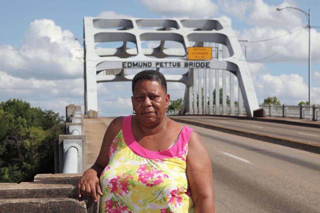 Joanne Bland stands on the Edmund Pettus Bridge in Selma, Alabama. As an 11-year-old in 1965, she joined a march on that bridge for what would become known as Bloody Sunday. The law-enforcement violence against protesters that day so shocked the nation that it led to the passage of the Voting Rights Act later that year. (Credit: Bill Ganzel/sixtiessurvivors.org)