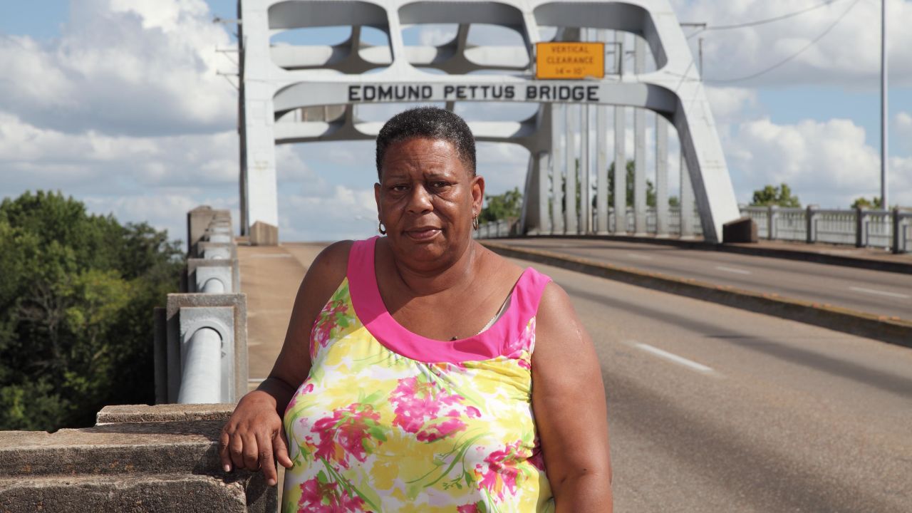 Joanne Bland stands on the Edmund Pettus Bridge in Selma, Alabama. As an 11-year-old in 1965, she joined a march on that bridge for what would become known as Bloody Sunday. The law-enforcement violence against protesters that day so shocked the nation that it led to the passage of the Voting Rights Act later that year. (Credit: Bill Ganzel/sixtiessurvivors.org)