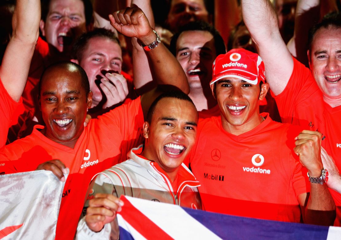 Lewis Hamilton celebrates his first world title in 2008 with father Anthony Hamilton and his brother Nicolas Hamilton.
