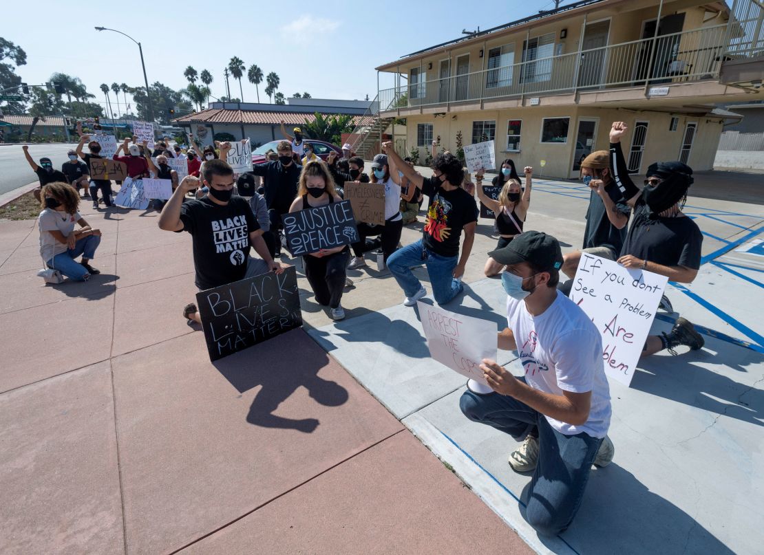 Protesters pause for a moment outside Hotel Miramar in San Clemente, California, on Thursday 
