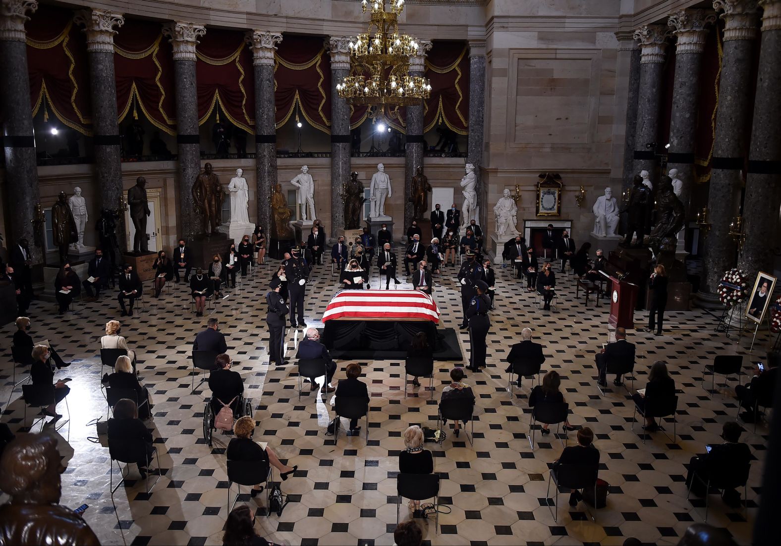 Members of Congress and guests pay their respects during a memorial service at the US Capitol on Friday.