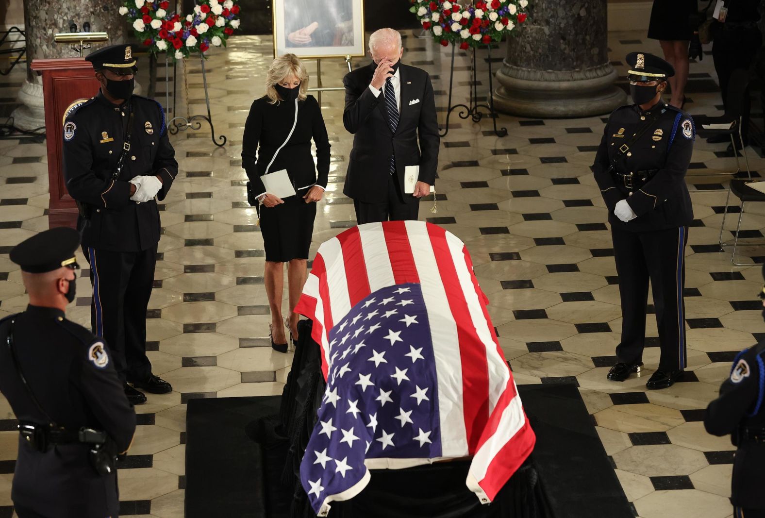 Democratic presidential nominee Joe Biden and his wife, Jill Biden, pay their respects during Friday's service.