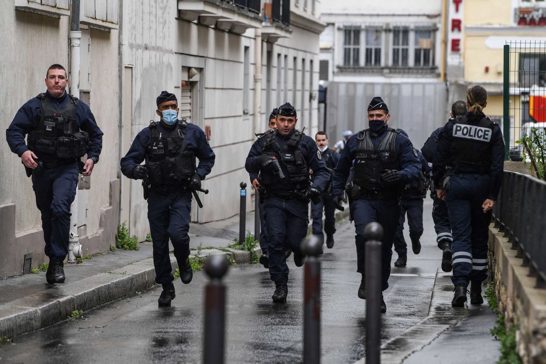 Police officers rush to the scene.