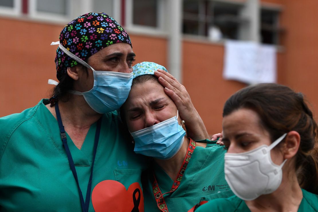 Healthcare workers acknowledge applause in memory of their co-worker Esteban, a male nurse who died of the coronavirus disease at the Severo Ochoa Hospital in Leganes, near Madrid, on April 10, 2020.