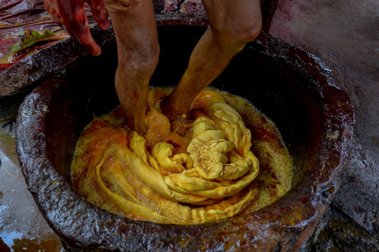 A man dyes fabric threads in a factory in Narsingdi, some 50 kilometers from the Bangladesh capital Dhaka, in July 2020.