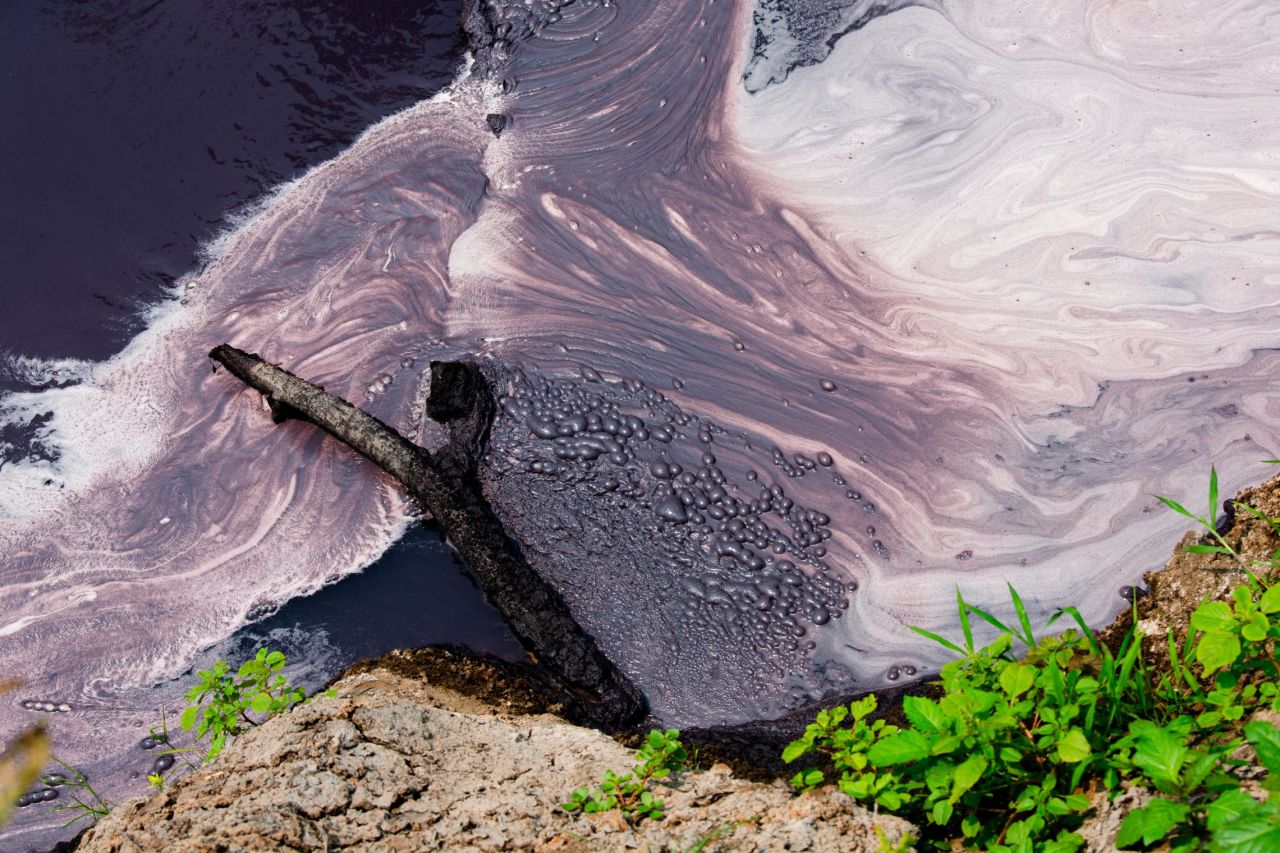 Factory waste including dyes from the many textile factories in the region drain into a tributary of the Citarum river outside Indonesia's Bandung in August 2018. 