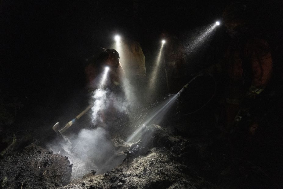 Inmate firefighters extinguish hot spots while working to contain the Bear Fire on September 24, 2020.