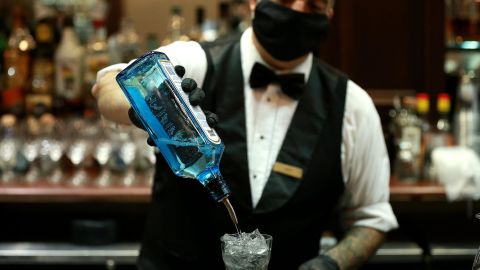A bartender pours a drink at Galatoire's Restaurant on May 22, 2020, in New Orleans, Louisiana. The City of New Orleans has allowed restaurants to also begin serving to-go drinks, as the city loosens restrictions.