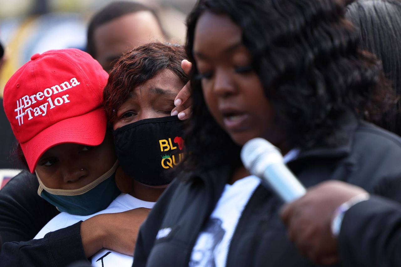 Ju'Niyah Palmer, Breonna Taylor's sister, wipes away tears from the face of her mother Tamika Palmer, Breonna Taylor's mother, as Bianca Austin, the aunt of Breonna Taylor, speaks at a press conference in Jefferson Square Park in Louisville on September 25.