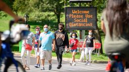 NEW YORK, NEW YORK - SEPTEMBER 06: People wear protective face masks near a social distancing sign in Central Park as the city continues Phase 4 of re-opening following restrictions imposed to slow the spread of coronavirus on September 6, 2020 in New York City. The fourth phase allows outdoor arts and entertainment, sporting events without fans and media production. (Photo by Noam Galai/Getty Images)