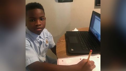 Ka'Mauri Harrison, 9, pictured in his Louisiana home participating in virtual learning.