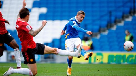 Trossard strikes the ball toward the Manchester United goal.