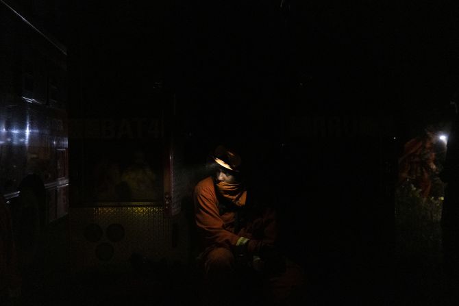 An inmate firefighter takes a break while working to contain the Bear Fire in Oroville, California, on September 24, 2020.