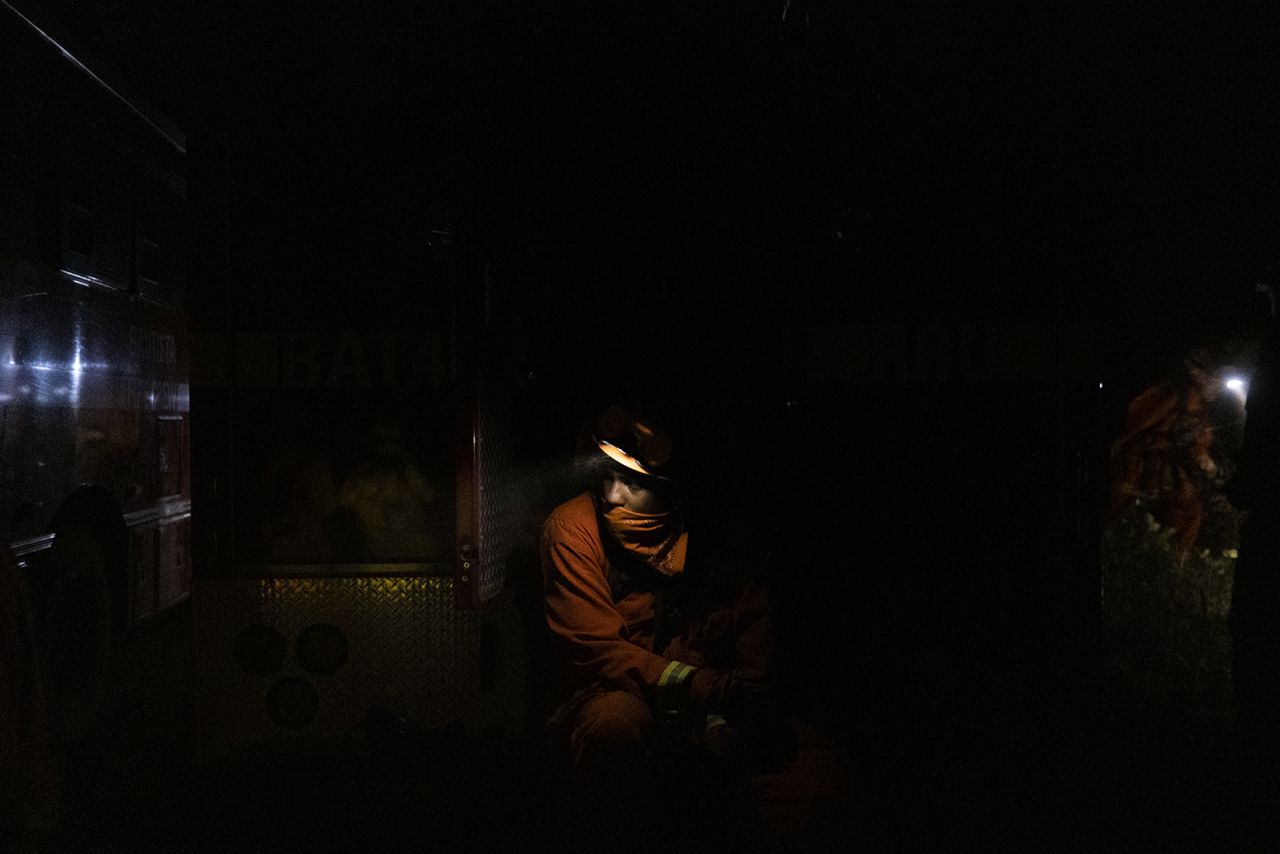 An inmate firefighter takes a break while working to contain the Bear Fire in Oroville, California, on September 24.