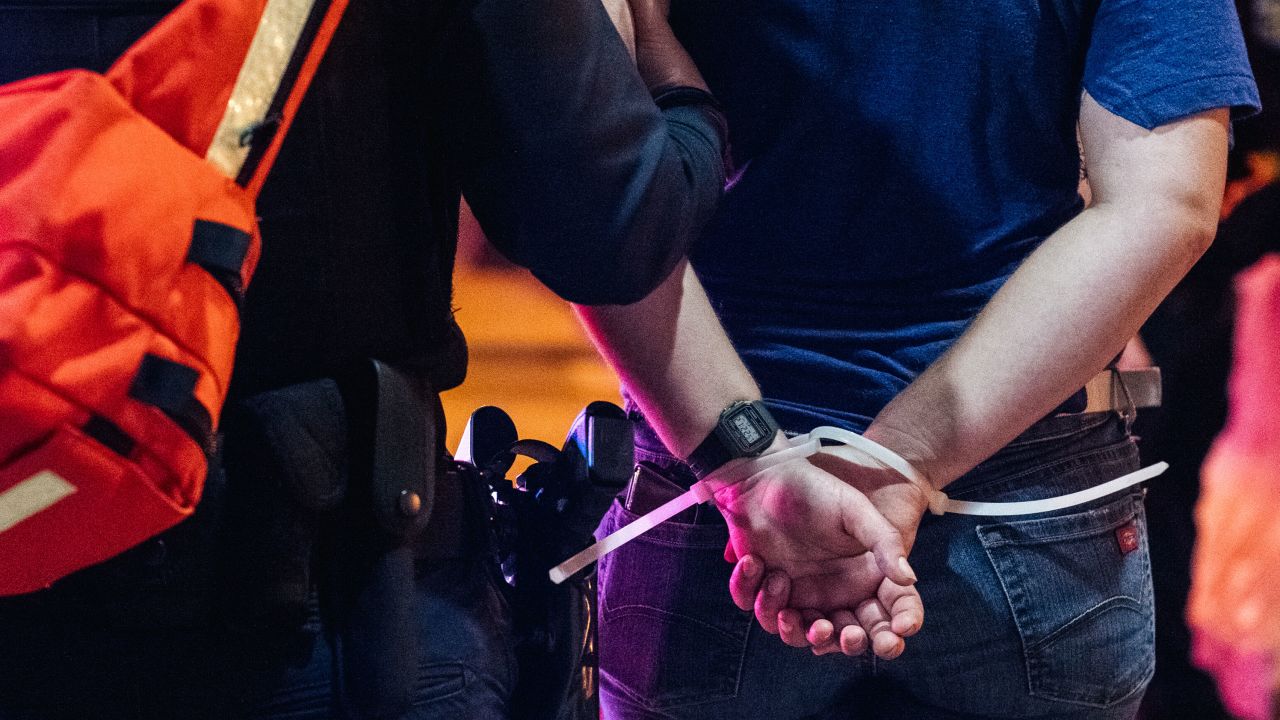 This protester was among 25 detained Saturday night in Louisville.
