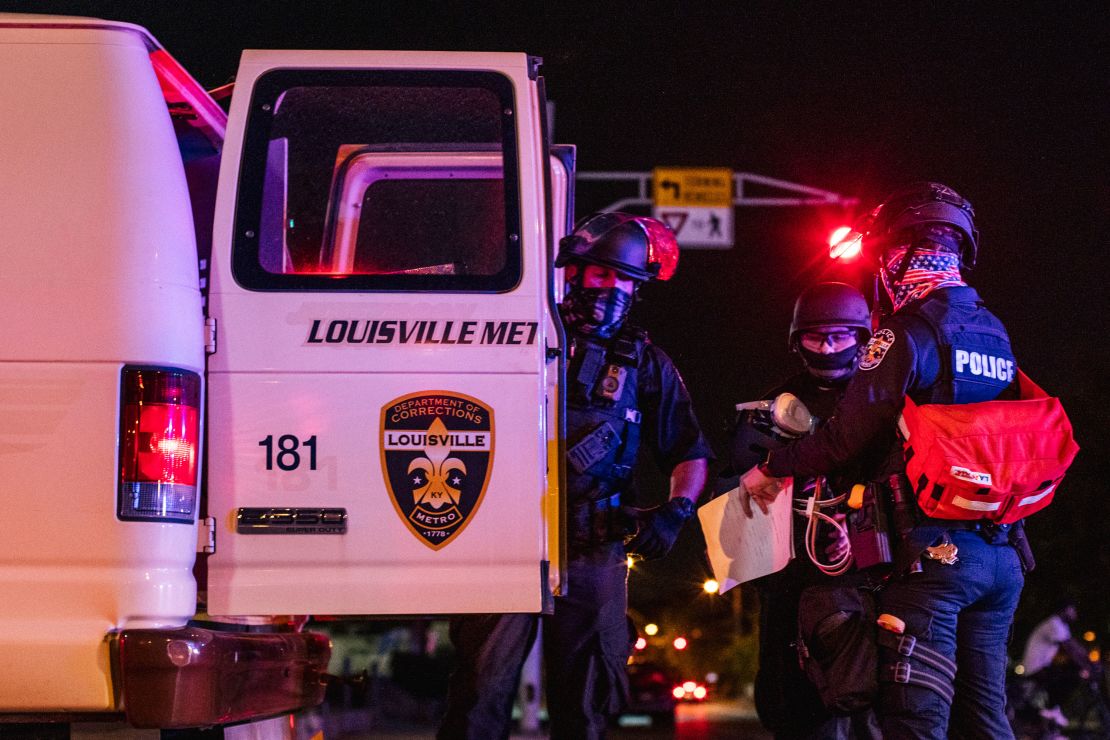 Police officers put a protester in the back of a van on Saturday in Louisville.