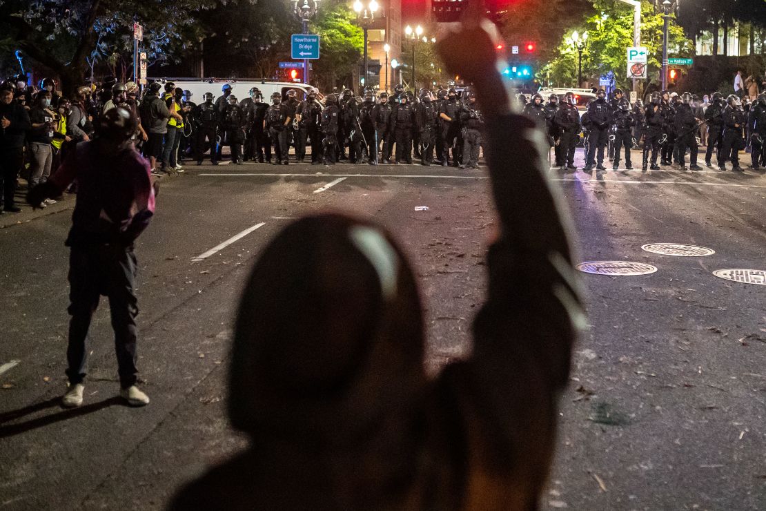 Protesters and police face off in Portland late Saturday. 