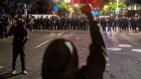 Protesters and police face off in Portland late Saturday. 