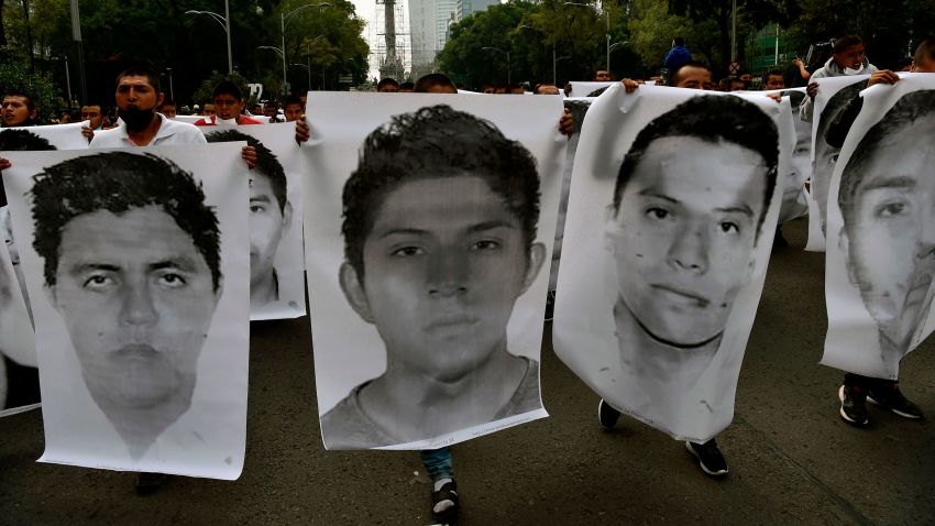 People protest in Mexico City on September 26, 2020, to mark six years of the disappearance of the 43 students of the teaching training school in Ayotzinapa who went missing on September 26, 2014. - The students, who had commandeered five buses to travel to a protest, were stopped by municipal police in the city of Iguala, Guerrero. Prosecutors initially said the officers delivered the 43 teacher trainees to drug cartel hitmen, who killed them, incinerated their bodies and dumped the remains in a river. However, independent experts from the Inter-American Commission on Human Rights have rejected the government's conclusion, and the unsolved case remains a stain on Mexico's reputation. (Photo by RODRIGO ARANGUA / AFP) (Photo by RODRIGO ARANGUA/AFP via Getty Images)