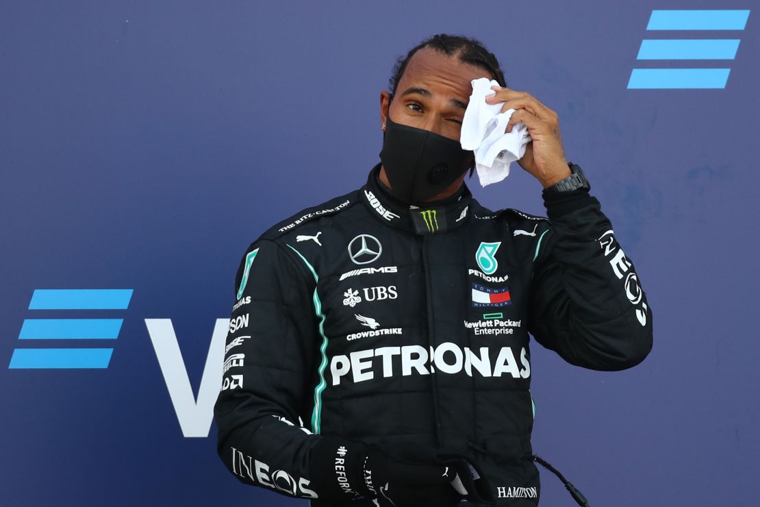 Hamilton reacts on the podium after finishing third in the Russian GP.