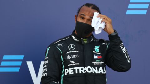 Hamilton reacts on the podium after finishing third in the Russian GP.