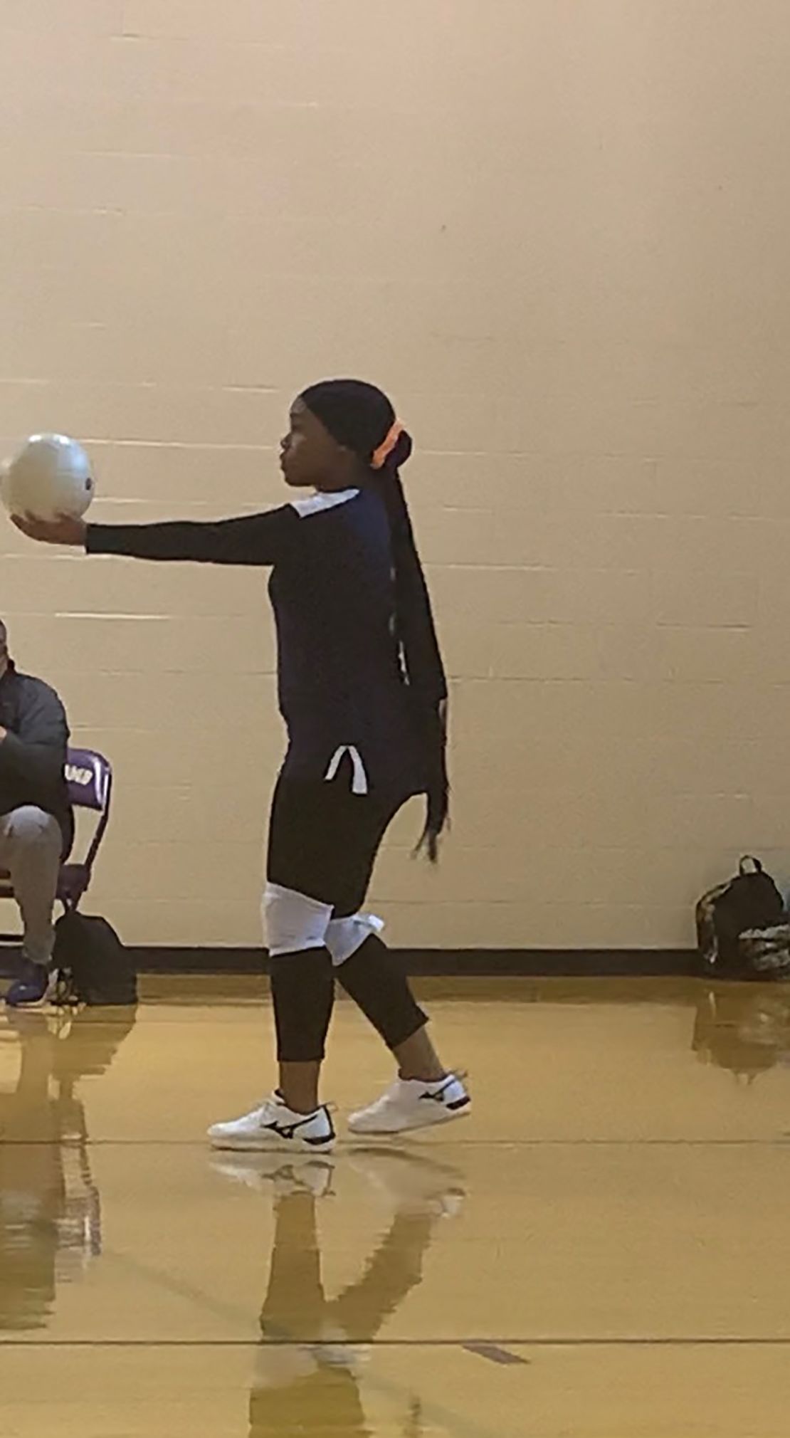 Najah playing volleyball in her hijab.