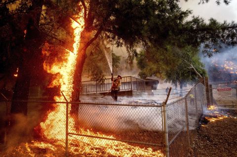 Cal Fire Capt. Jesse Campbell works to save the Louis Stralla Water Treatment Plant as the Glass Fire burns in St. Helena.