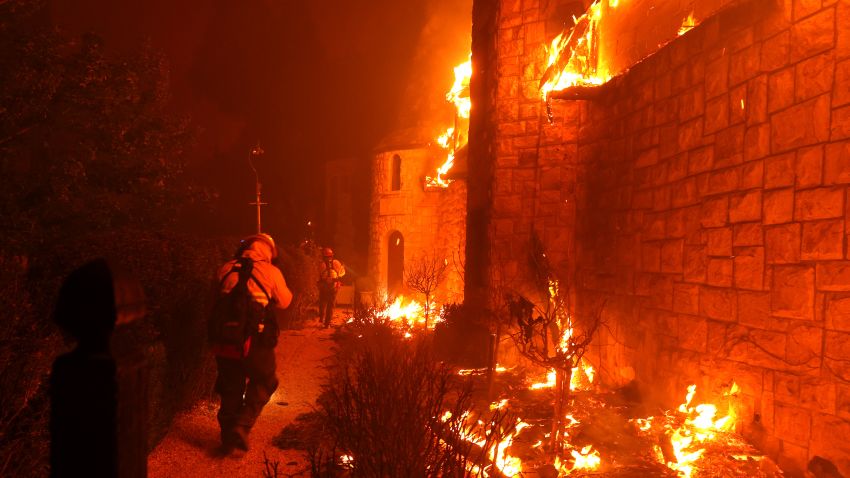 ST. HELENA, CALIFORNIA - SEPTEMBER 27: Firefighters walk through the burning Chateau Boswell Winery as the Glass Fire moves through the area on September 27, 2020 in St. Helena, California. The fast moving Glass fire has burned over 1,500 acres and has destroyed homes. Much of Northern California is under a red flag warning for high fire danger through Monday evening. (Photo by Justin Sullivan/Getty Images)