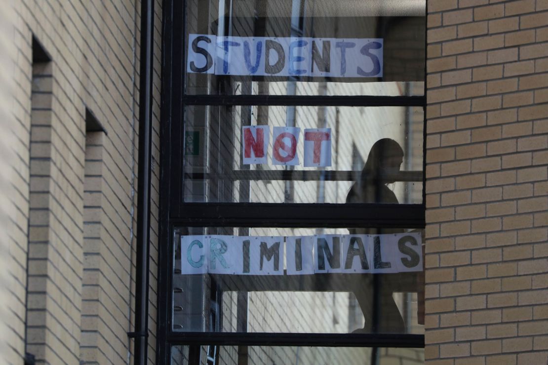 A student walks past a sign at Murano Street Student Village in Glasgow, after Glasgow University students were told to quarantine.