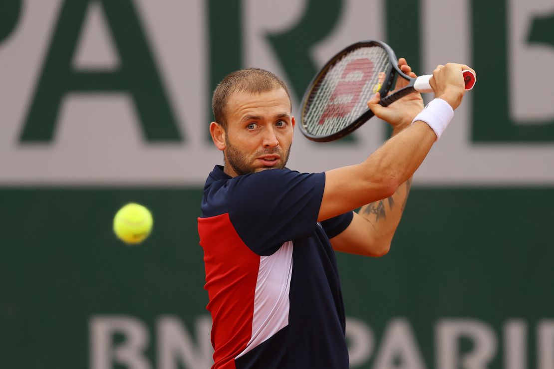 Evans plays a backhand during his defeat by Kei Nishikori at the French Open.