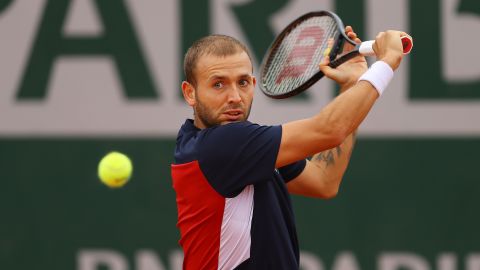 Evans plays a backhand during his defeat by Kei Nishikori at the French Open.