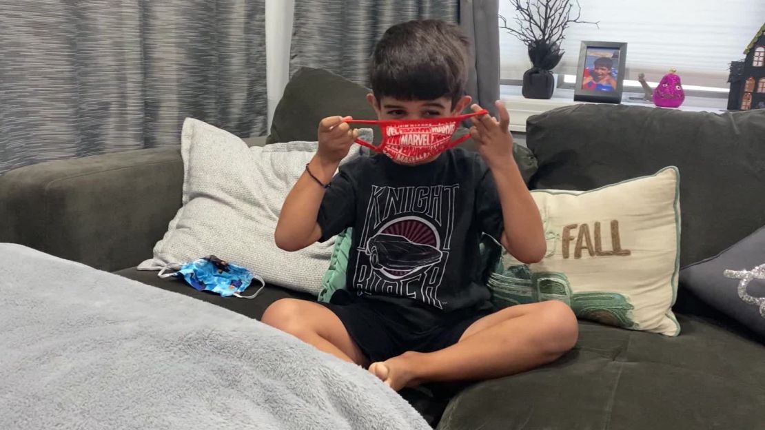 Andonios Anastsiou, practices putting his mask on as he prepares to go back to school in New York City.